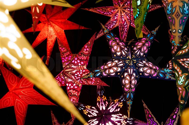 Colorful Christmas stars. A background of star lanterns, stock photo