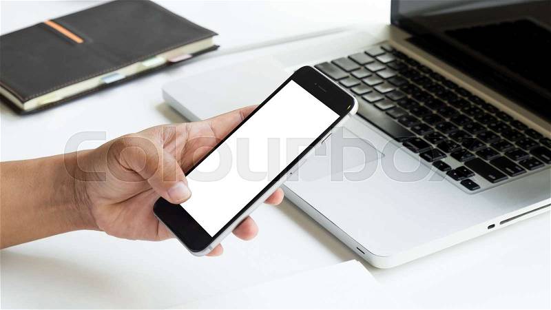 Hand use phone blank screen top view in office morning light, stock photo