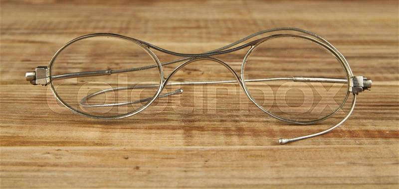 Old glasses on a wooden background, stock photo