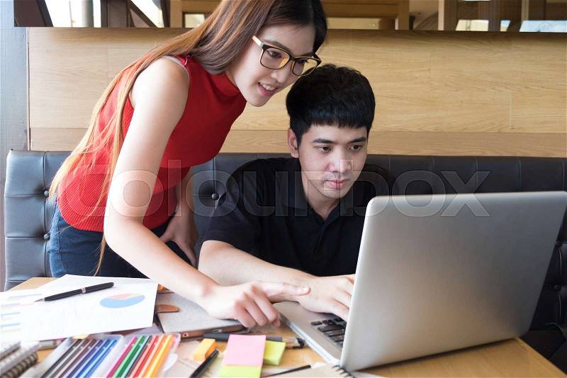 Young studying friends doing homework task for lecture, stock photo