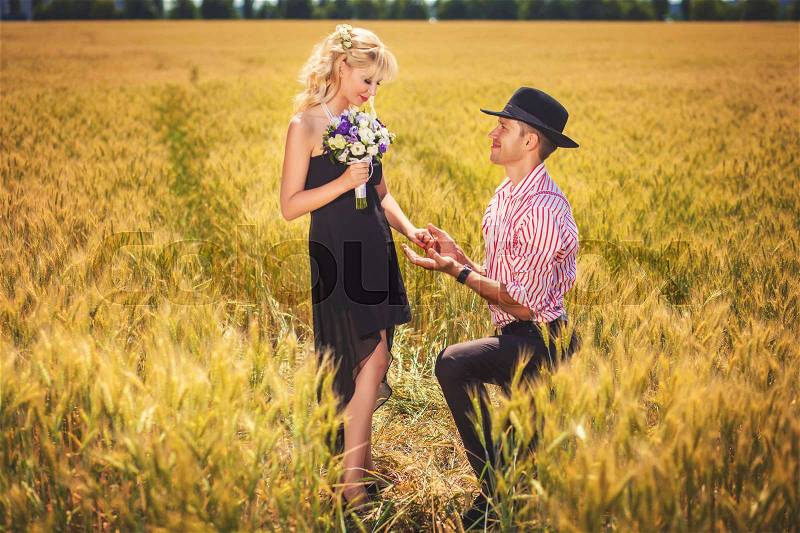 Boyfriend and girlfriend together on the beautiful wheat field, stock photo