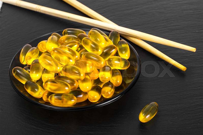 Fish oil supplements in soft gel capsule, healthy product concept. Studio Photo, stock photo