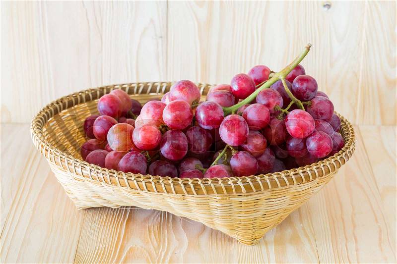 Grape in a fruit tray on a wooden background, stock photo