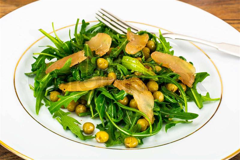Salad with Arugula, Peas, Jerked Chicken, Mix of Peppers and Vegetable Oil Studio Photo, stock photo