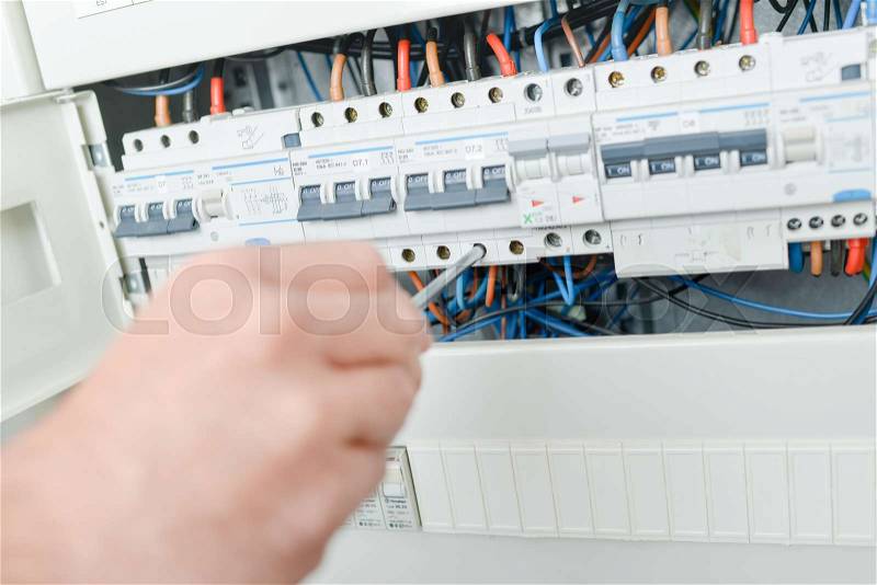 Electrician repairing a fuse, stock photo