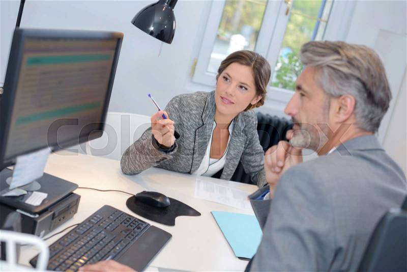 Man dealing with a financial adviser at the bank, stock photo