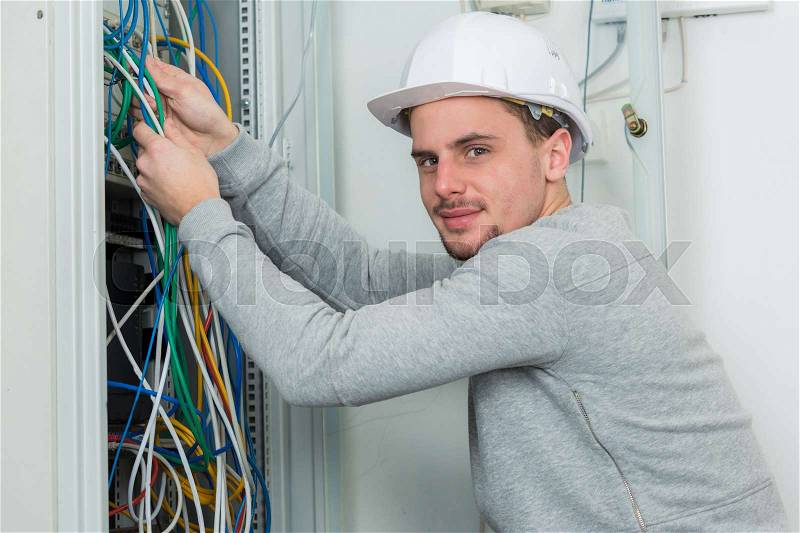 A man working on electric wire, stock photo