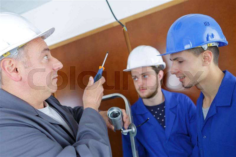Manager of team builders showing how to work indoors, stock photo