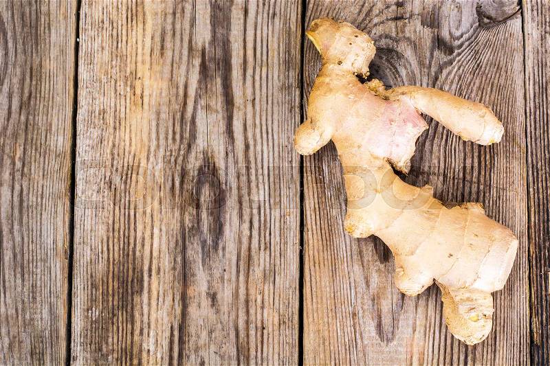 Fleshy fragrant ginger root on wood. Studio Photo, stock photo