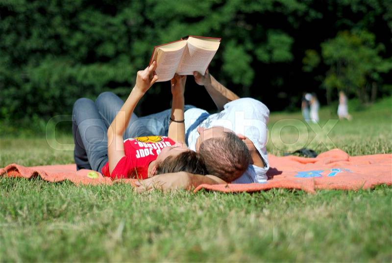 Beautiful, Happy Couple Having Picnic and Reading Outside , stock photo