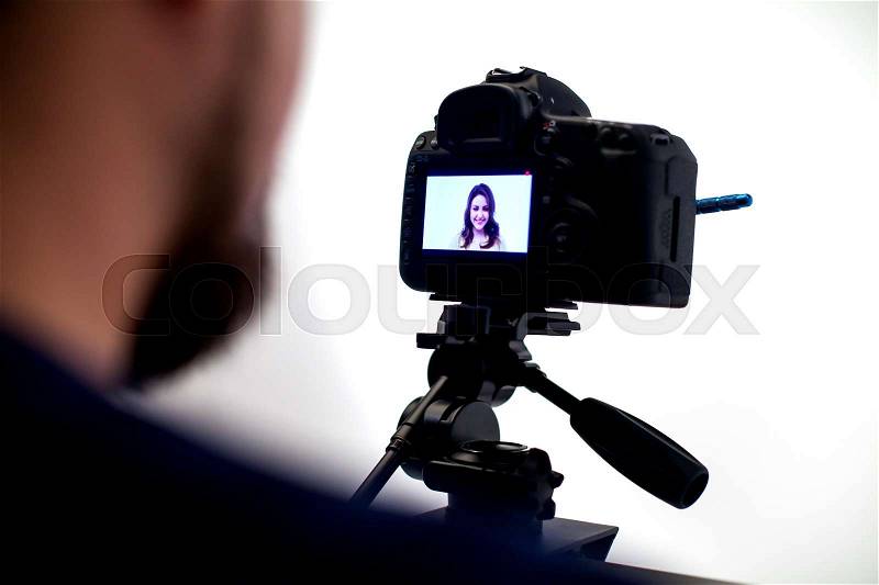 Backstage from video studio. Photografer works with camera, stock photo