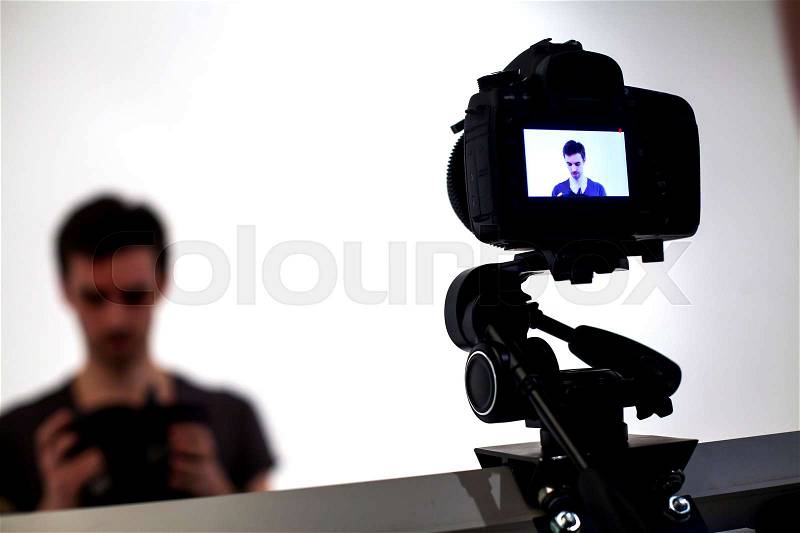 Backstage from video studio with man going to wear virtual reality headset, stock photo