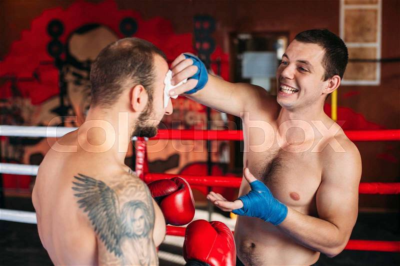Box fighters trainning. Boxing ring on the background, stock photo