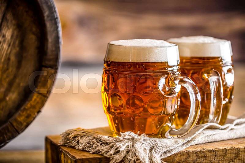 Beer. Two cold beers. Draft beer. Draft ale. Golden beer. Golden ale. Two gold beer with froth on top. Draft cold beer in glass jars in home pub hotel or restaurant. Still life, stock photo