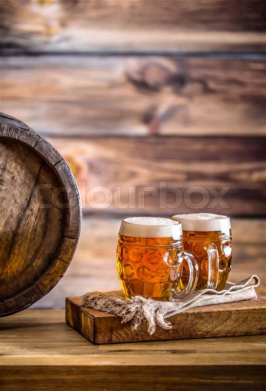 Beer. Two cold beers. Draft beer. Draft ale. Golden beer. Golden ale. Two gold beer with froth on top. Draft cold beer in glass jars in home pub hotel or restaurant. Still life, stock photo
