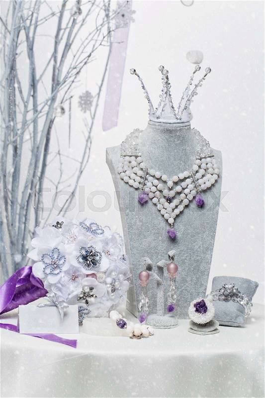 Beautiful set of natural stone bridal accessories including necklace, ring, earrings, bracelets, princess crown and wedding bouquet. , stock photo