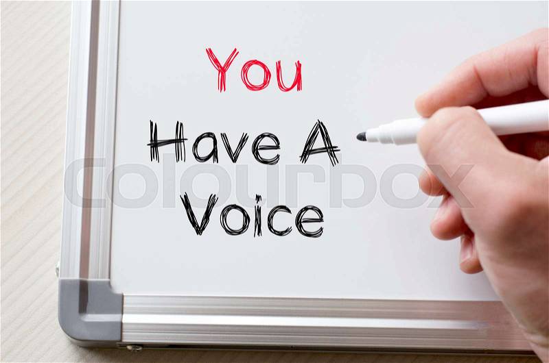 Human hand writing you have a voice on whiteboard, stock photo