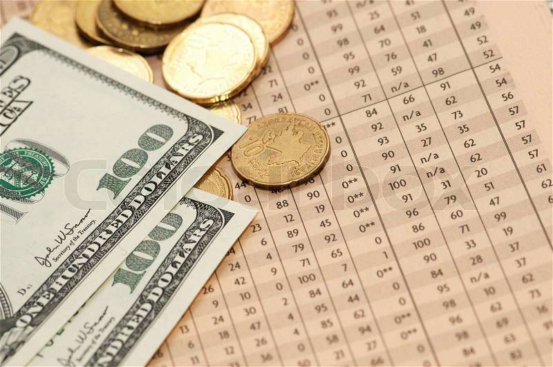 Coins and dollars over financial numbers from newspapers, stock photo