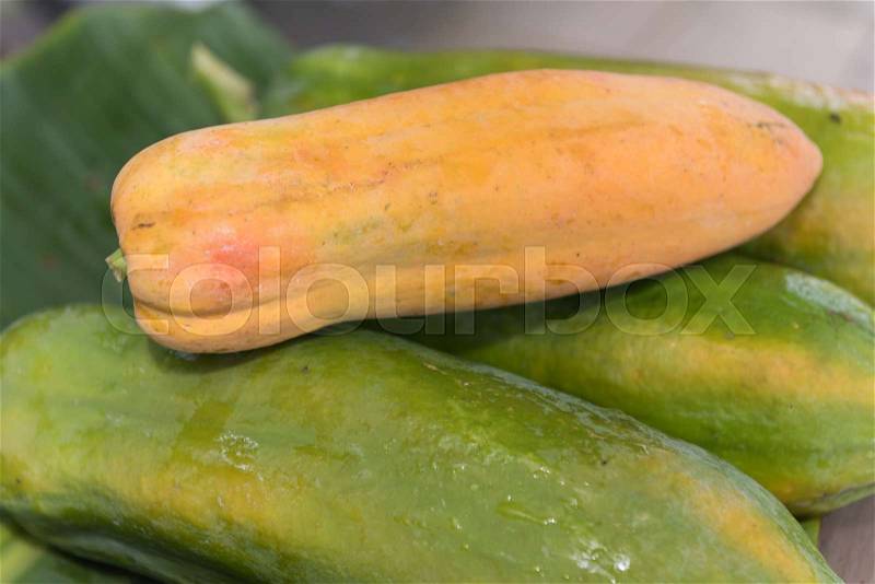 Fresh papaya fruit on green banana leave background,still life, stock photo