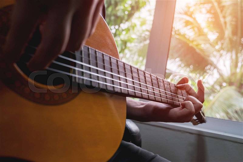 Acoustic guitar guitarist playing. Musical instrument with performer hands, stock photo