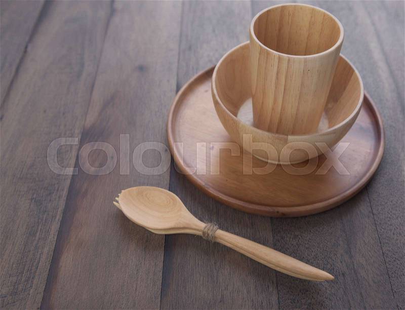 Wood kitchen utensils over grunge wooden table background, stock photo
