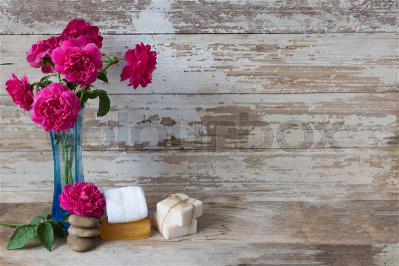Spa concept with coconut soap,zen stone and beautiful rose flowers on grunge wooden background , stock photo