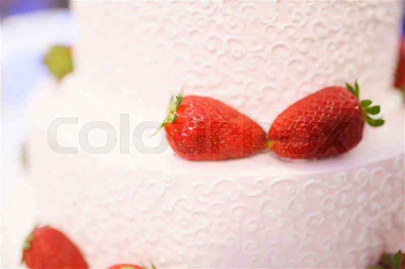 Sweet Wedding cake decorated with tasty strawberries, stock photo