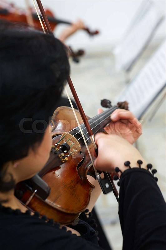 Woman Violinist Playing Classical Violin Music in Musical Performance, stock photo