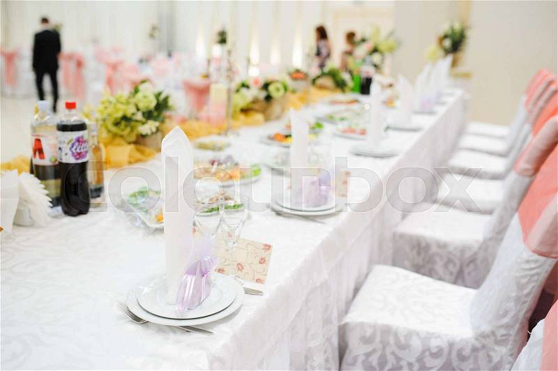 Banquet wedding table setting on evening reception awaiting guests, stock photo