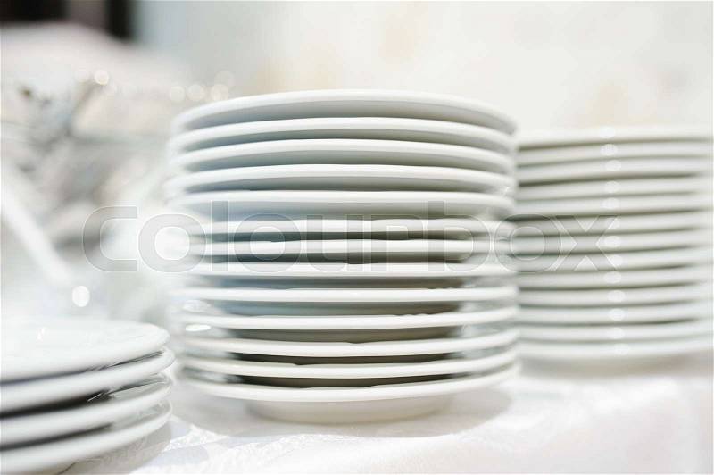 Stack of clean plates ready to be used on dinner, stock photo