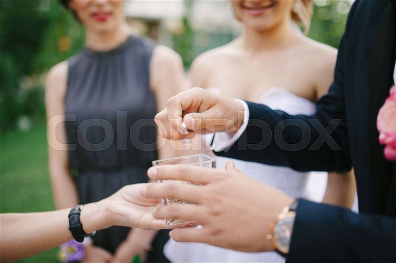 Bride and groom are changing rings on their wedding, stock photo