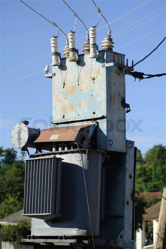 High voltage electricity transformer station against blue sky, stock photo