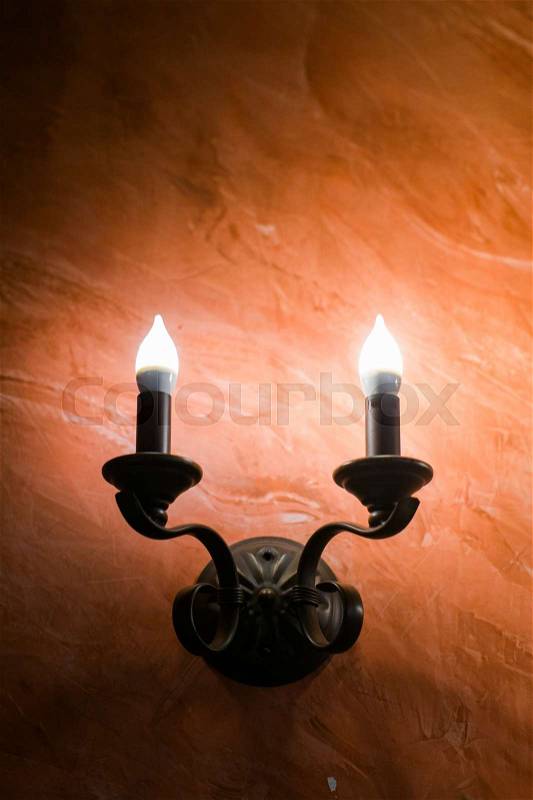 Vintage chandelier or wall candle lamp at hotel, stock photo