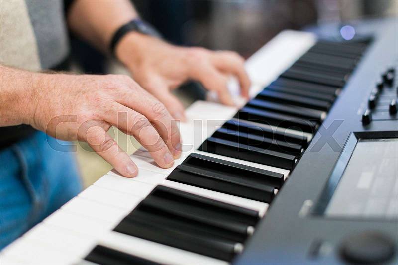 Keyboard player performing on stage live concert, stock photo