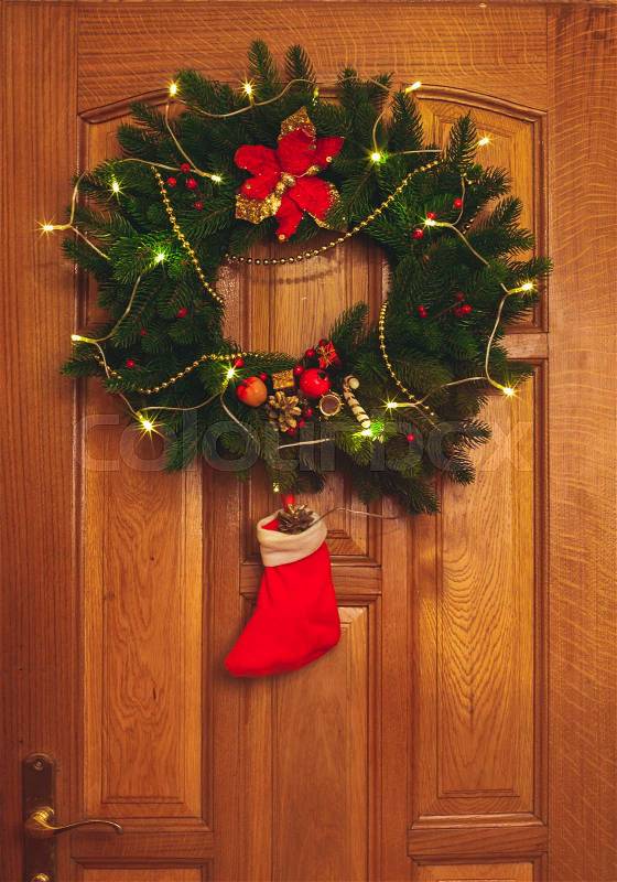 Christmas wreath with red sock on the door, stock photo