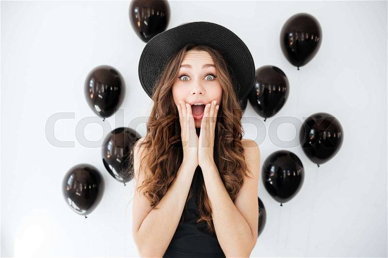 Happy surprised young woman with opened mouth, stock photo