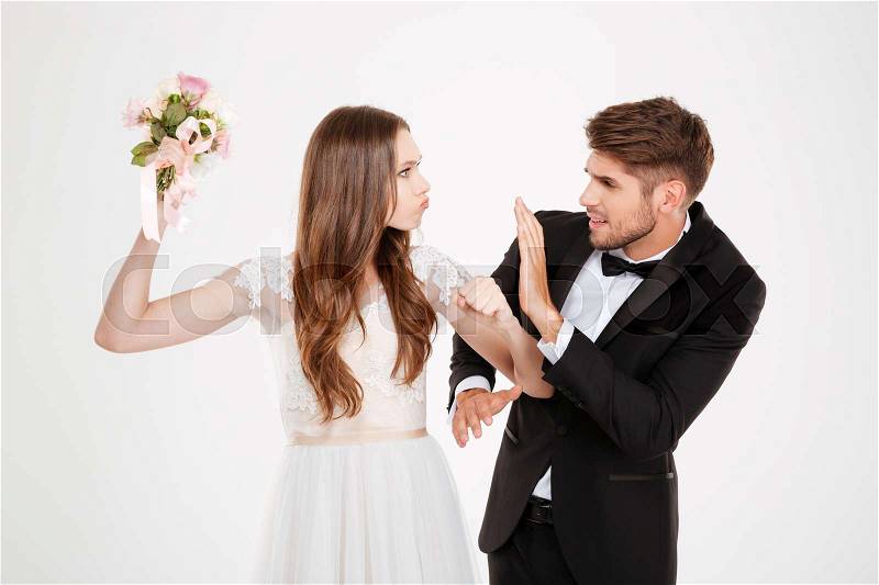 Conflict couple with bouquet. white background, stock photo