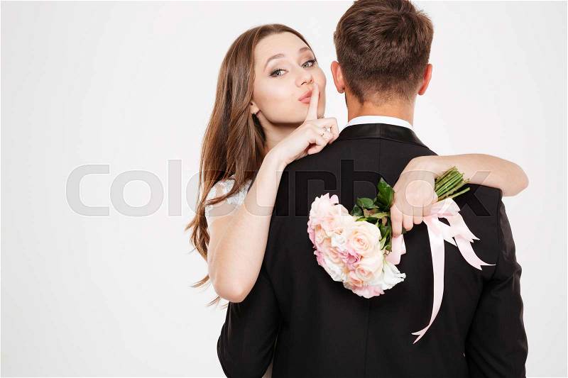 Newlyweds in arms. with bouquet, stock photo