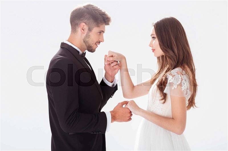 Groom kisses the bride\'s hand. eyes to eyes, stock photo