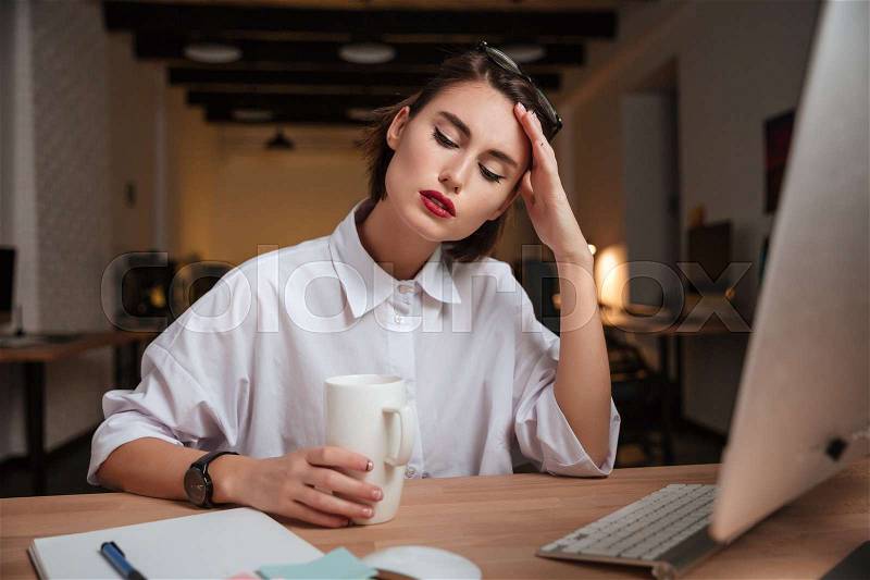 Weary office girl. hand near the face, stock photo