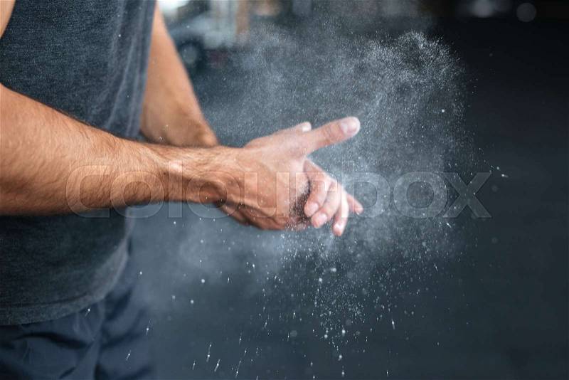 Photo of fitness hands. rubbing hands with chalk, stock photo