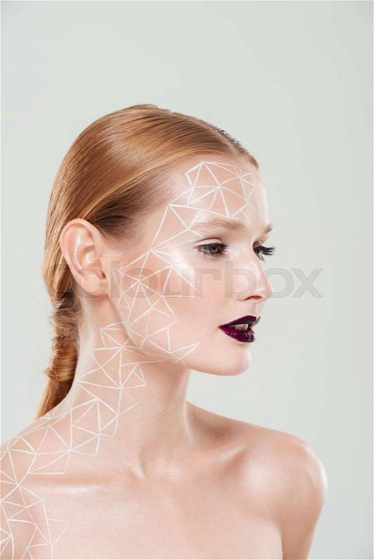 Beauty portrait in profile of woman with body art. Close up. Gray background, stock photo