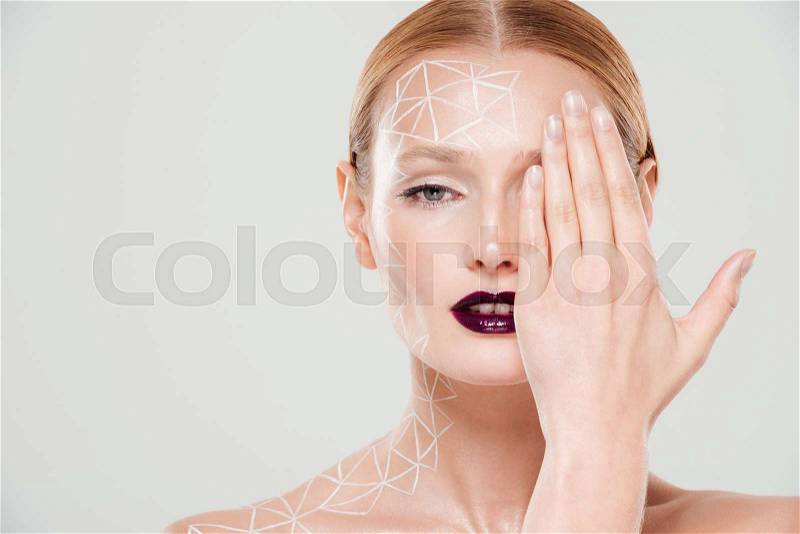 Pretty model with body art closes her eye. Close up. Beautiful make up. Isolated gray background, stock photo