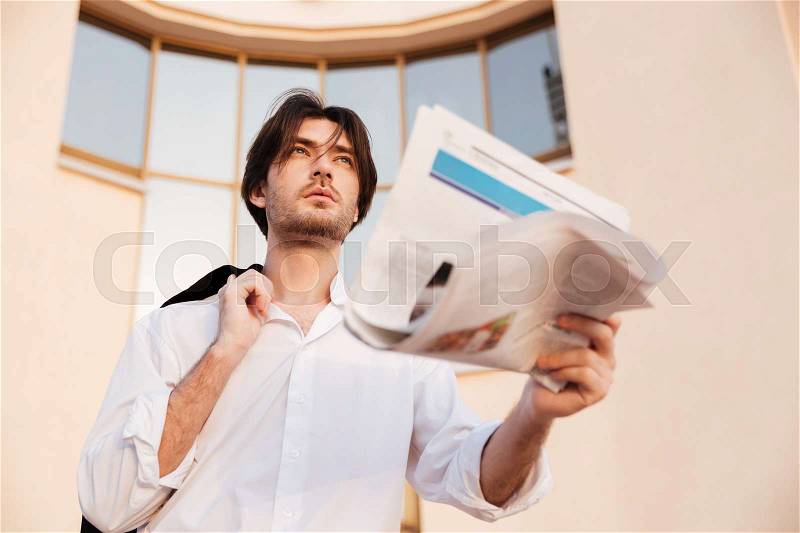 Handsome man in shirt with newspaper. so cool photo, stock photo