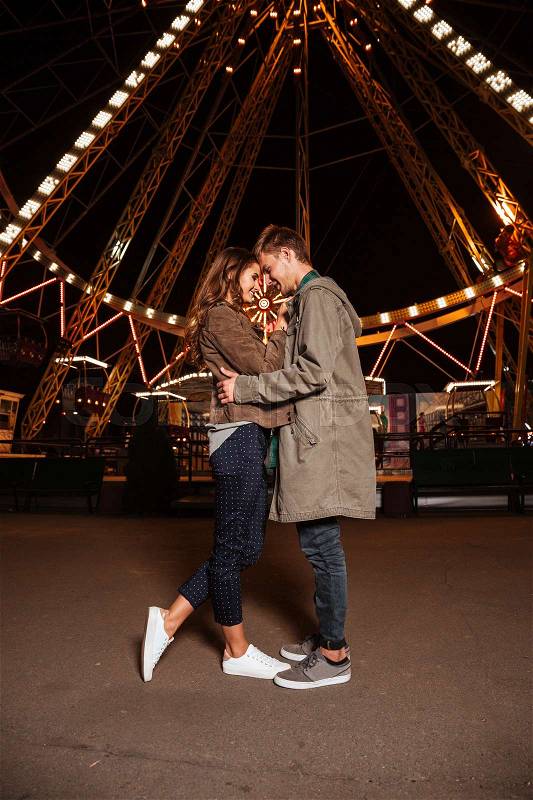 Young couple posing together at an attractions park. in warm clothes. full length, stock photo