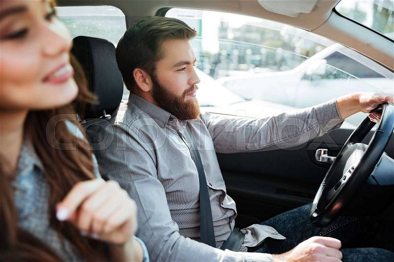 Side view of pretty couple in car. cropped image. man at the wheel, stock photo