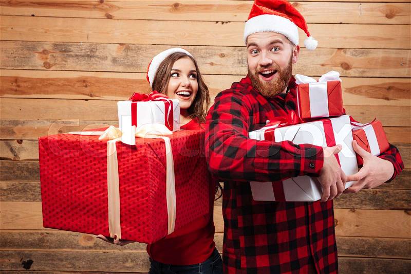 Funny friends with gifts. many gifts. wooden background, stock photo