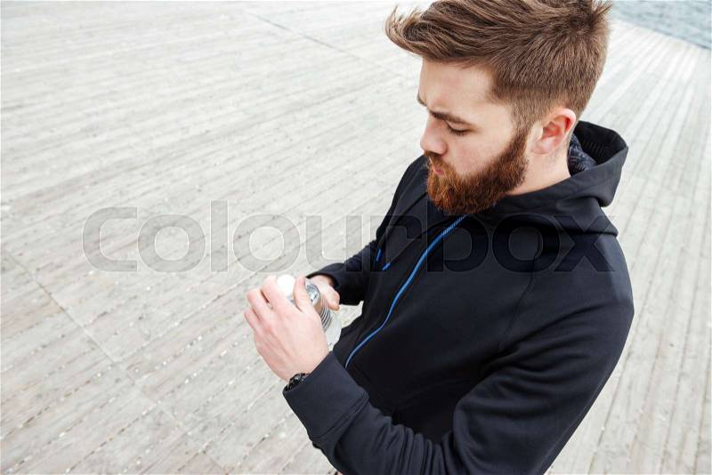 Young runner with water. side view, stock photo
