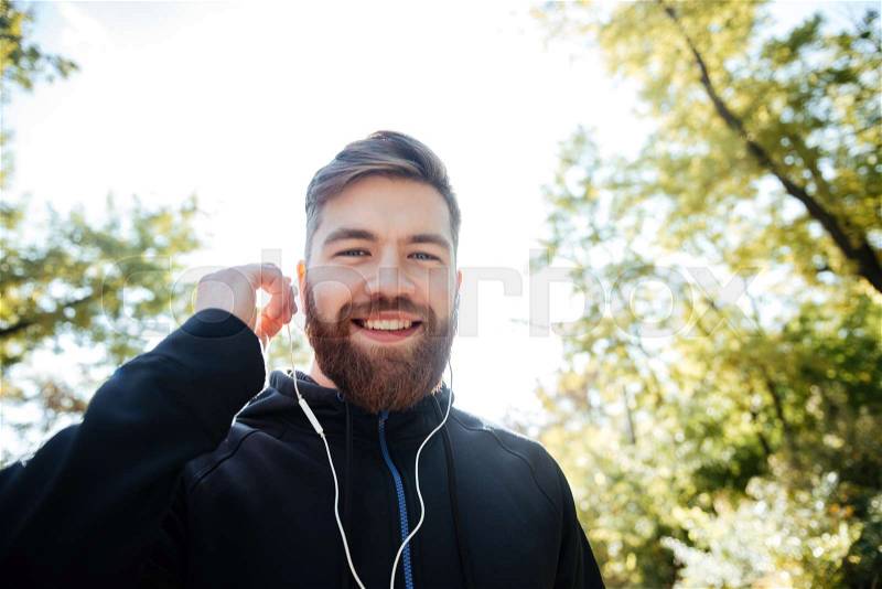 Happy runner in park. from below. looking at camera, stock photo