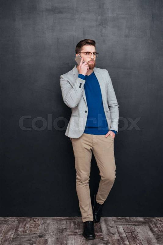 Full length image of hipster with phone. isolated black background, stock photo